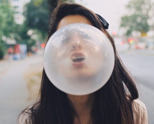 Girl Blowing A Bubblegum